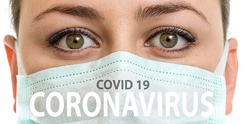 Close up of female nurse wearing mask with text Covid 19 Coronavirus on the mask